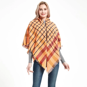 Plaid shawl wrap with orange and black checkered pattern and fringe trim tassels