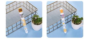 Detail of multi-color ballpoint pen with hamburger topper and blue lattice pattern