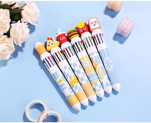 Macro view of multi-color ballpoint pens with cartoon food toppers and checkered patterns