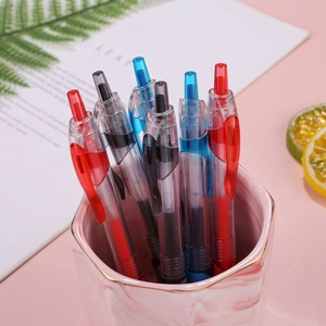 Retractable gel ink pens in red, blue, and black with a marble desk organizer