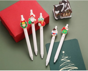Close-up of 5-piece Christmas gel pen set with Santa and snowman silicone charms