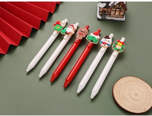 Detail shot of 6 Christmas themed pens featuring Santa Claus and snowman silicone toppers