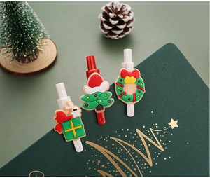 Close-up of Christmas gel pens featuring festive tree, wreath, and gift box clip designs