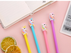 Detailed view of four colorful unicorn gel pens arranged on a pink desk setting