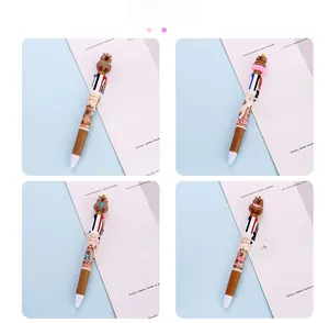 Detailed view of four different 3D capybara topper multi-color ballpoint pens