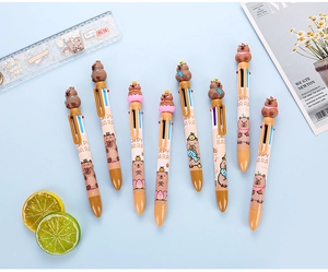 Close-up of 8 capybara multi-color pens with 3D toppers on a light blue background