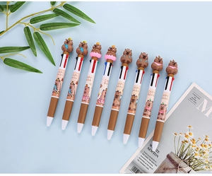 Detail of 3D cartoon capybara toppers on colorful multi-color retractable ballpoint pens