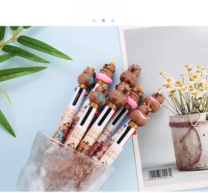 Detail of multi-color capybara ballpoint pens with 3D resin toppers in a desk organizer