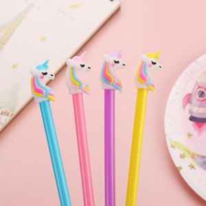 Set of four colorful unicorn gel pens in pink, blue, purple, and yellow on a pastel desk