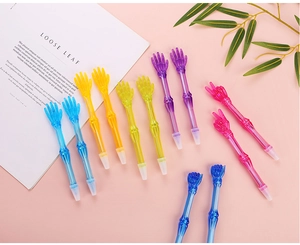 Close-up of skeleton hand gesture ballpoint pens in five vibrant translucent colors