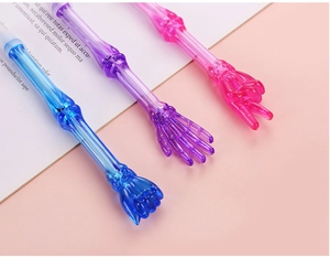 Close-up of skeleton-style gesture pens in blue, purple, and pink on a desk