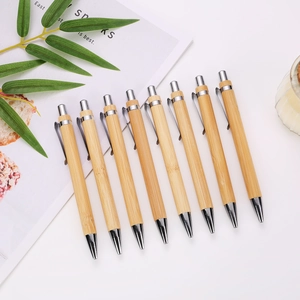 Detailed close-up of 8 bamboo retractable ballpoint pens with polished silver metal accents