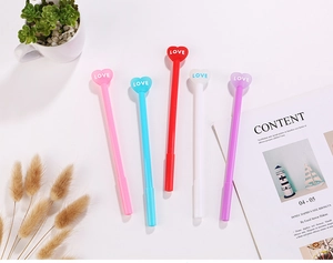 Detail of cute heart-shaped pens with LOVE text in pink, blue, red, white, and purple