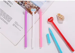 Detailed view of colorful heart-shaped gel pens with LOVE engraving in five colors