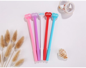 Detailed flat lay of five heart-top pens in assorted pastel colors for office use