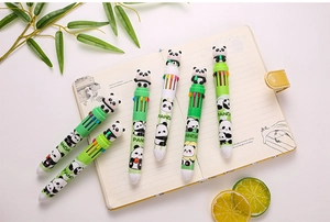 Close-up of 10-in-1 panda retractable ballpoint pens with cartoon figures on notebook
