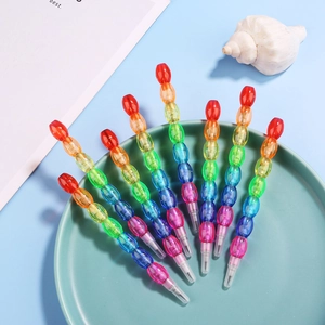 Detail of colorful stackable pencils with seven translucent segments in a blue bowl