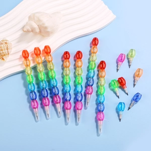 Detail of colorful stackable rainbow pencils on blue background with decorative shells