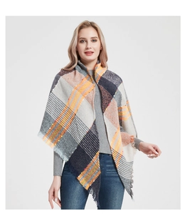 Close-up of fluffy texture and fringed edges on a colorful plaid triangle scarf shawl