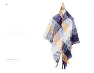 Detail of navy and orange plaid scarf with fringe tassels on a mannequin display