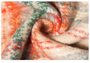 Close-up of soft brushed mohair-style fabric with orange and green plaid texture