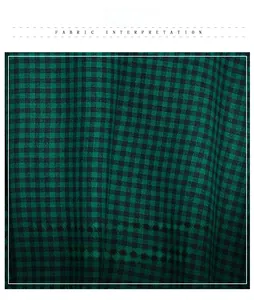 Close-up of green and black gingham scarf showing the soft cashmere-like fabric texture