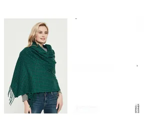 Detail view of green and black houndstooth check scarf with elegant fringe trim