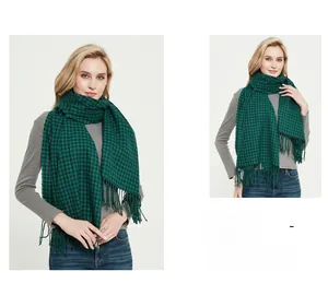 Detailed view of green and black checkered scarf with soft fringed edge and thick texture
