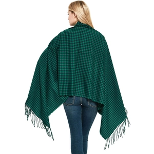 Women's green and black plaid cashmere shawl with fringe tassels shown on model back