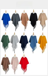 Multi-color collection of knitted tassel ponchos showing various shades and textures