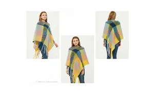 Detail view of multi-color plaid knit poncho with thick fringe tassels for autumn and winter