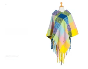 Detail of colorful plaid poncho with long fringe trim and thick knit texture