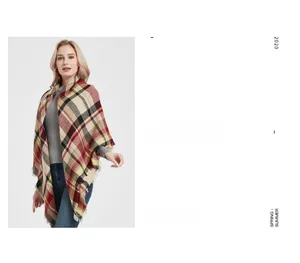 Detail of red and beige checkered cashmere-feel shawl with classic frayed fringe edges