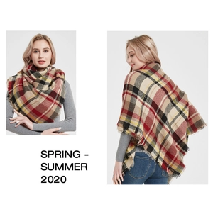 Detail of red and beige tartan scarf featuring soft cashmere-feel fabric and frayed edges