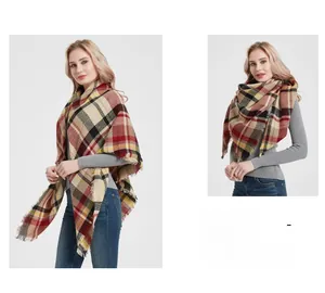Detail of red and beige checkered cashmere-feel scarf with natural fringe edges