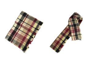 Detail of classic plaid cashmere-like scarf with soft fringes and red-black checkered pattern