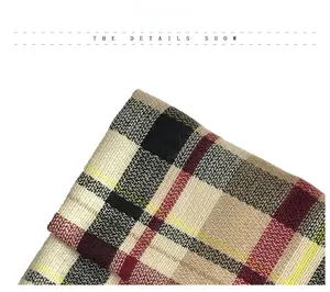 Close-up of tartan pattern fabric showing texture of red and black checkered scarf