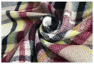 Close-up of soft plaid scarf fabric showing thick woven texture and colorful patterns