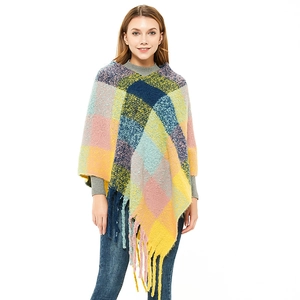 Women's colorful plaid knit poncho with vibrant checked patterns and thick fringe details
