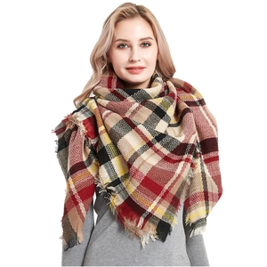 Classic colorful plaid cashmere-like scarf with fringe tassels worn by a model