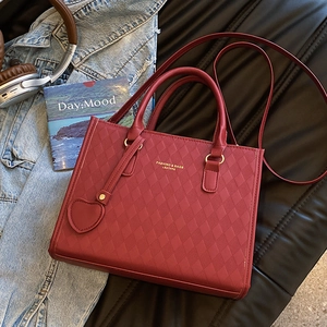 Deep wine red quilted faux leather tote bag with heart pendant and gold branding