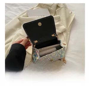 Detail view of sparkly sequin bag interior showing storage space for phone and small wallet