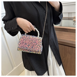 Detail of colorful sequins and pearl handle on a fashionable evening crossbody bag