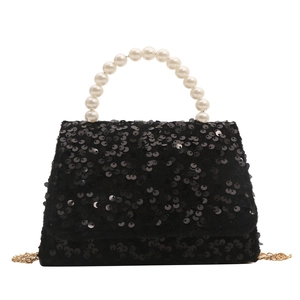 Black sequin handbag with white pearl handle and gold chain strap on white background