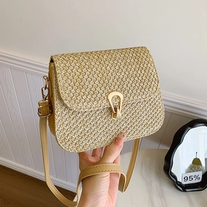 Woven straw crossbody bag with golden horseshoe buckle and adjustable leather strap