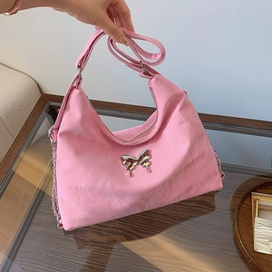 Pink hobo shoulder bag with silver butterfly buckle and textured fabric finish