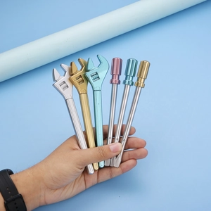 Creative wrench shaped pens in metallic gold, silver, and colorful finishes held by hand
