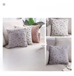 Detail of plush feather throw pillows with gold foil pattern in grey, white and pink