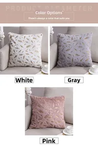 Detail of plush throw pillow with gold foil feather pattern on beige sofa with flowers