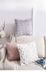 Close-up of feather gold stamping on plush purple and pink throw pillow covers